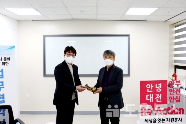 성열우 청년회장이 구자행 센터장에게 TAK 기념 트로피를 전달하고 있다.